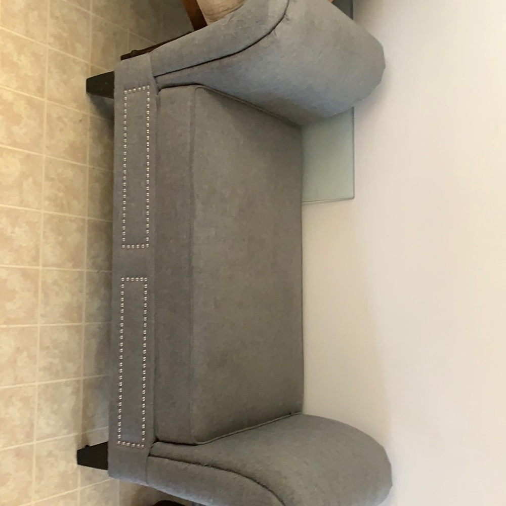 A nice stable gray window seat that is in good condition.